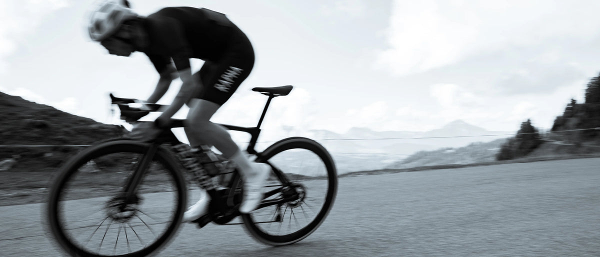 A rider on a Pearson Shift 2.0 at speed on an alpine road above Morzine